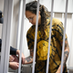 A policeman removes the handcuffs from WNBA star and two-time Olympic gold medalist Brittney Griner in a courtroom prior to a hearing in the Khimki district court, just outside Moscow, Russia, Friday, July 15, 2022.